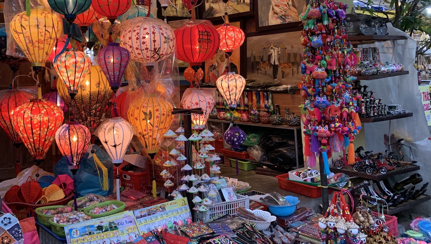 Puesto callejero en Hoi An con farolillos encendidos y souvenirs